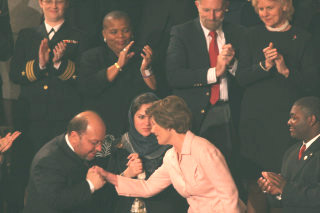 Hamid Gilani, vice-president of Afghan senate, kisses the hand of Laura Bush